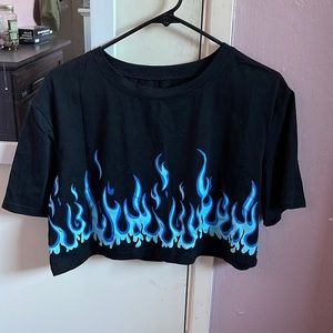 Black crop top with blue flames at the end.